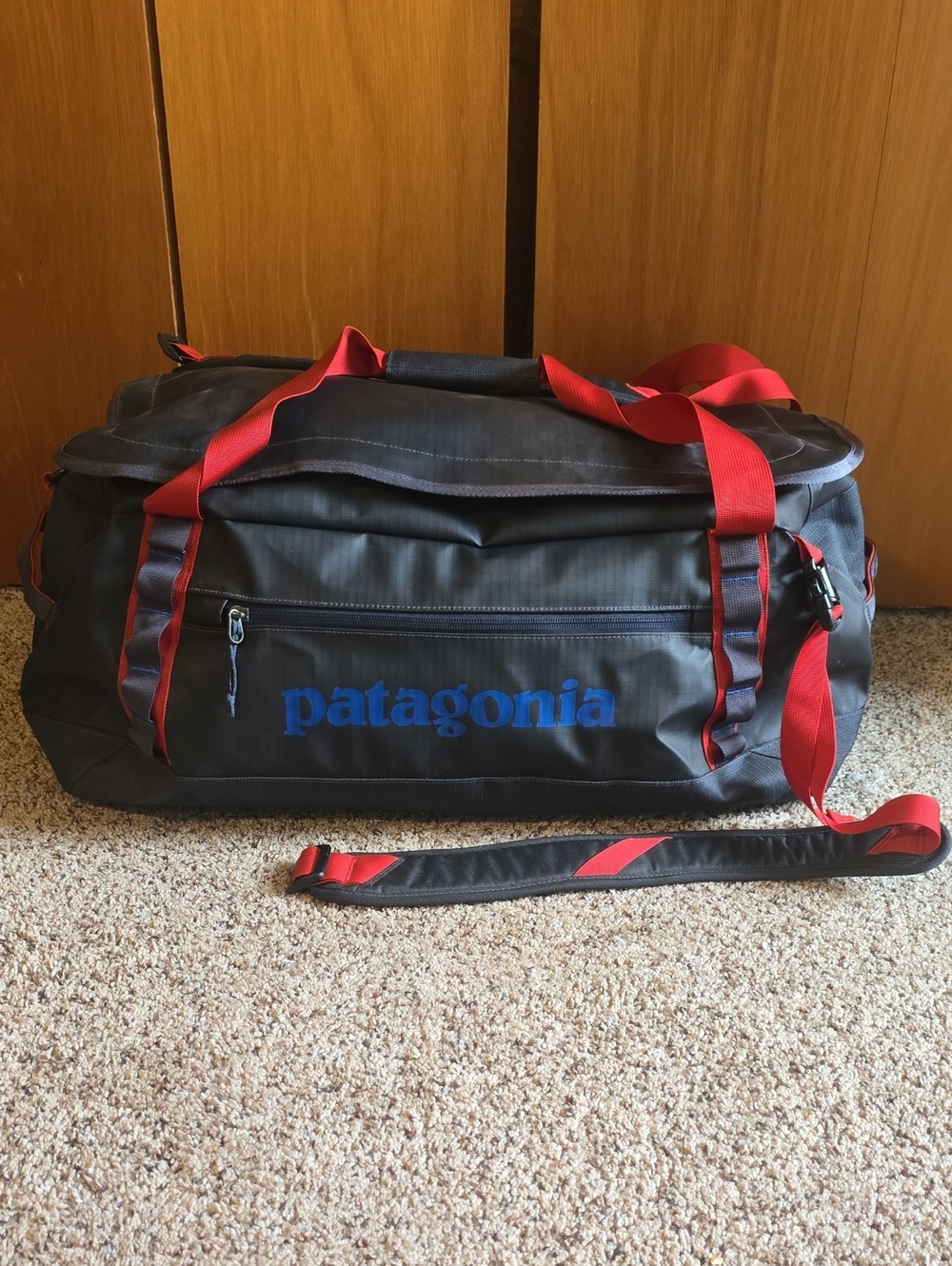 Patagonia Gray Duffel Bag with Red Straps and Blue Logo